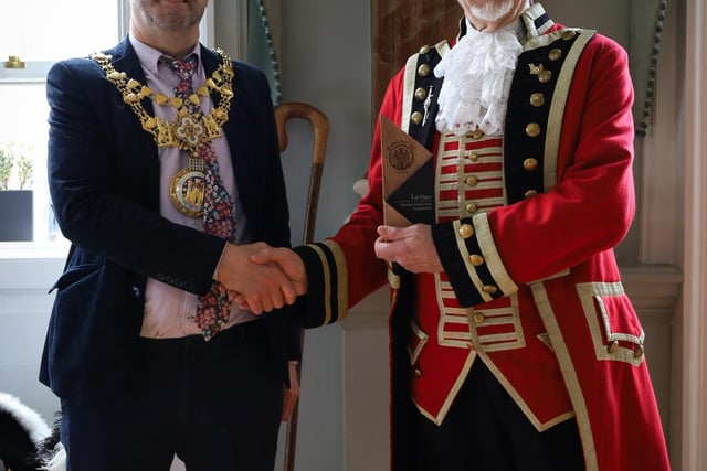 The Mayor of Warwick, Cllr Oliver Jacques presenting a trophy to the winner crier Adrian Holmes from Lichfield.