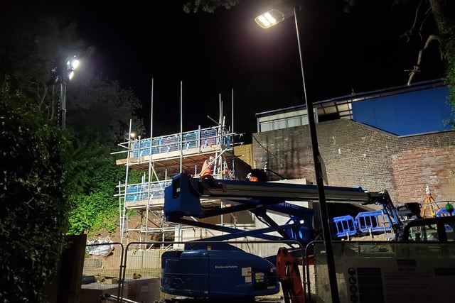 The staff waiting for the new lift shaft to be moved into place.