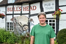 Martin Peel, 52, alongside the new mural at The Bull's Head Pub in Wootten Wawen. Photo by Emma Trimble / SWNS