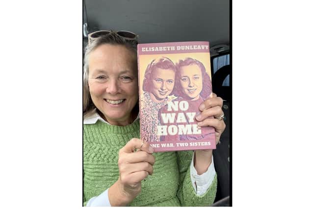 Elisabeth Dunleavy with a copy of her book No Way Home.