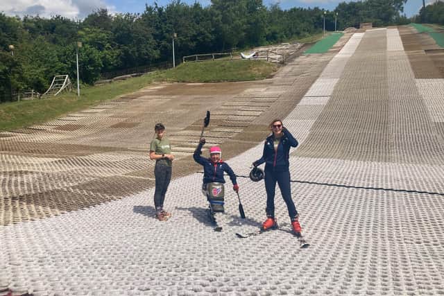 Anna Turney on the dry ski slope at Ackers Adventure, with Running Out of Time support team members either side. Photo supplied