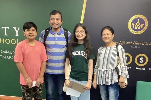 Rohini (pictured with her family) achieved three Grade 9s and six Grade 8s. Photo by Trinity Catholic School