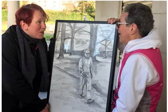 Tony receiving the drawing from artist Jenny Suffield. Photo supplied