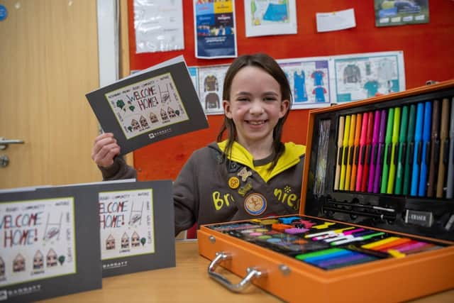 Amelia with her winning card and art set