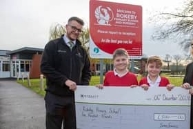 Dan presents the cheque for £500 to Rokeby Primary School