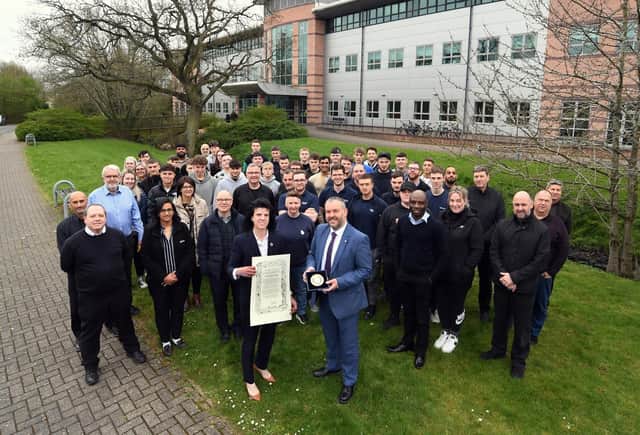 Angela Joyce and Alan May (front) with staff, students and apprentices at Warwick Trident College. Photo supplied