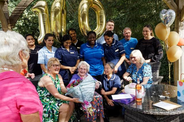 Vera Shepherd surrounded by family and staff in the garden at Kineton Manor