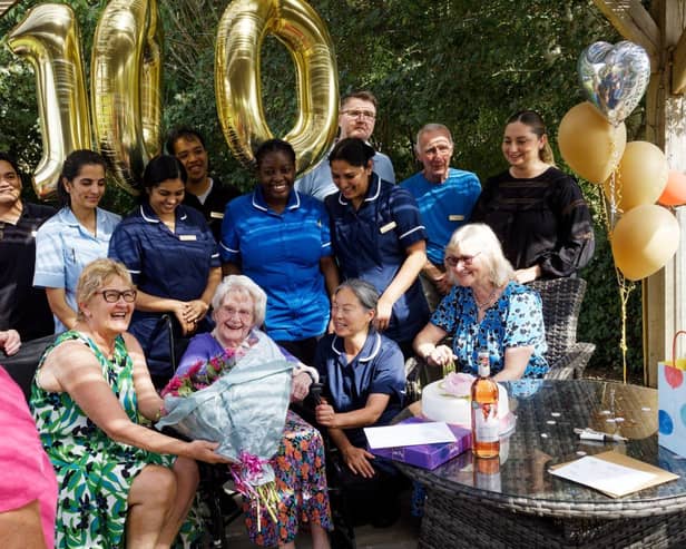 Vera Shepherd surrounded by family and staff in the garden at Kineton Manor