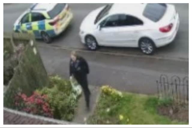 CCTV footage of a Warwickshire Police officer visiting LInda Bromley's home in Warwick on Friday March 14.