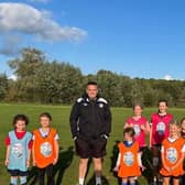 Everyone Active coach Richard Bell with some of the Shipston Wildcat girls’ football players.