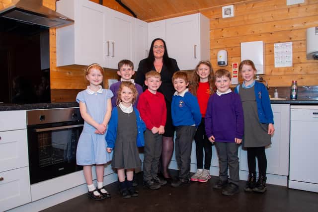 Esther McCarthy of child care provider Happy Days with youngsters in the new kitchen at the Cliff Cleaver pavilion in Cubbington.
