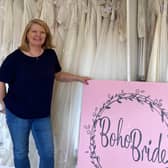 Lynette Turner of Boho Brides hands over the wedding dresses to Rachel Ollerenshaw of Molly Ollys. Photo supplied