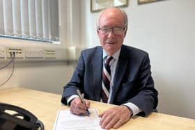 Warwickshire Police and Crime Commissioner Philip Seccombe signs the oath of office for his third term in the position