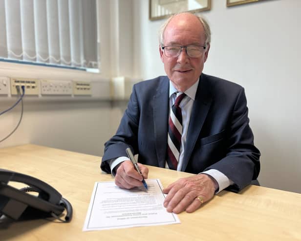 Warwickshire Police and Crime Commissioner Philip Seccombe signs the oath of office for his third term in the position