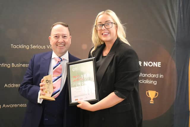 Warwickshire Pride Trustee, Ian Brookes-Howells presenting a representative from Hart and Co in Leamington the Best LGBTQ+ Venue award. Photo by Warwickshire County Council