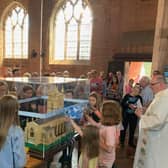 Visitors enjoy looking at the model of the church.