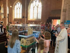 Visitors enjoy looking at the model of the church.