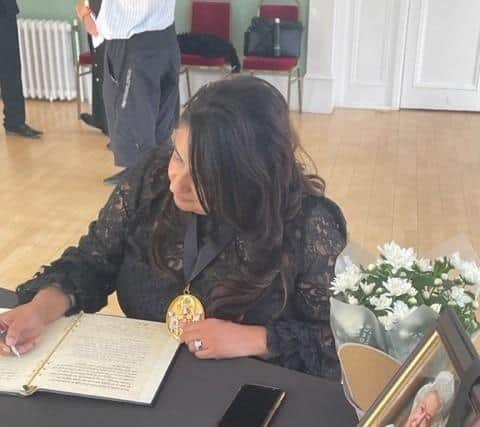 Warwick District Council chair Cllr Mini Kaur Mangat signs the formal book of condolence for the death of Queen Elizabeth II. The book has now been opened to the public in the Royal Pump Rooms in Leamington.  Picture supplied.