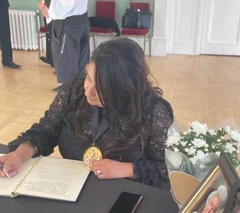 Warwick District Council chair Cllr Mini Kaur Mangat signs the formal book of condolence for the death of Queen Elizabeth II. The book has now been opened to the public in the Royal Pump Rooms in Leamington. Picture supplied.