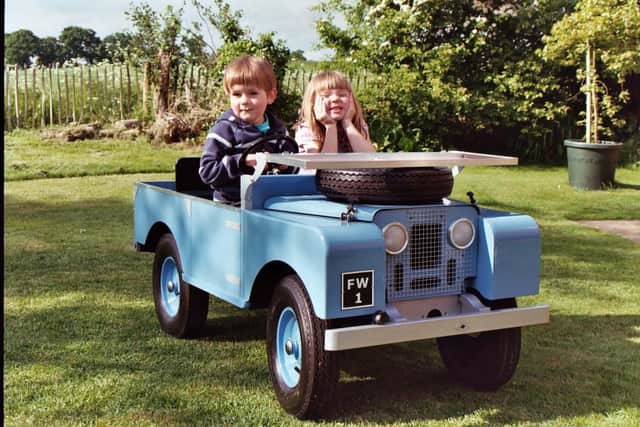 Andy's children in the now stolen blue Land Rover Defender that was made for them by their grandfather.
