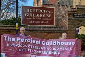 Guildhouse Centenary Committee Chairman, David Dove and Centre Manager Sarah Gall with the banner celebrating 100 years of adult education in Rugby.