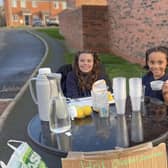 Selling lemonade for struggling families.