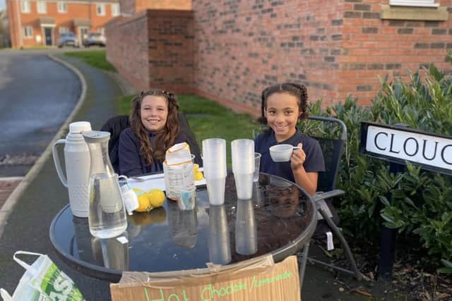 Selling lemonade for struggling families.