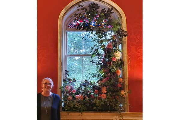 Nicola Hill with her floral window creation. Photo supplied