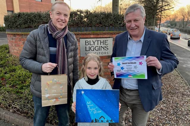Rosie Russell, the winner of the Blythe Liggins Christmas art competition, with her winning entry. Pictured with Dad Andy Russell and David Lester, senior partner at Blythe Liggins Solicitors.