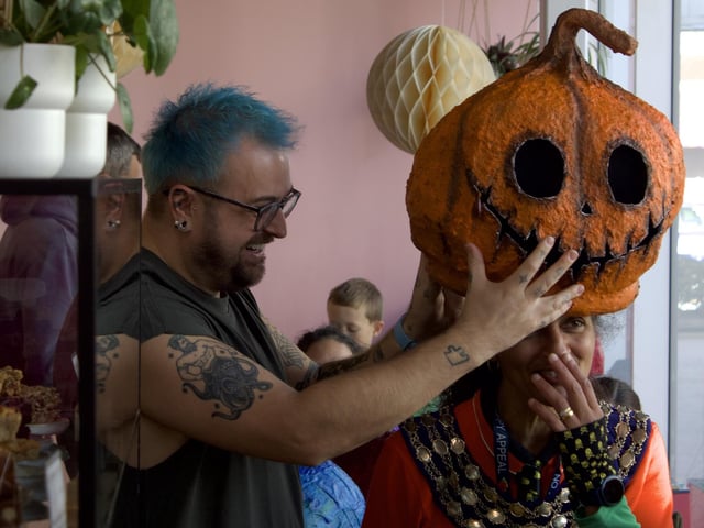 The Mayor of Kenilworth trying on a pumpkin head.