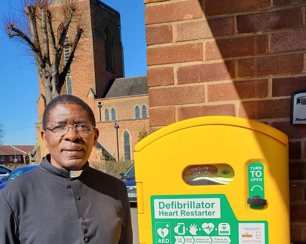 Father Jimmy Lutwama with the defibrillator at Our Lady of the Angels RC Church
