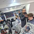 The friends have their hair shaved at Magic Scissors.