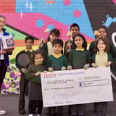 Shrubland Street pupils with headteacher Nicola Mills receving the cheque and kitchen equipment from Tesco Community Champion Melissa Hazell. Photo by John Bray.
