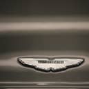 GAYDON, ENGLAND - JANUARY 10:  An Aston Martin logo known as the 'Wings' adorns the bonnet of a Vanquish at the company headquarters and production plant on January 10, 2013 in Gaydon, England. The iconic British brand is celebrating its 100th anniversary. Lionel Martin and Robert Bamford created Bamford & Martin on January 15 1913, which later became Aston Martin in honour of Bamford’s wins at the Aston Clinton Hillclimb in Buckinghamshire.  (Photo by Christopher Furlong/Getty Images)