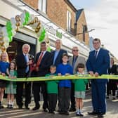 Paul Elverson (vice president of the Heart of England Co-operative Society), Gary Haigh (director), Clive Miles (president), Ali Kurji (chief executive), Ian Pepall (head of central operations), Colin Brown (director), Scott Arlidge (director) with pupils from Hillmorton Primary School.