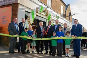 Paul Elverson (vice president of the Heart of England Co-operative Society), Gary Haigh (director), Clive Miles (president), Ali Kurji (chief executive), Ian Pepall (head of central operations), Colin Brown (director), Scott Arlidge (director) with pupils from Hillmorton Primary School.