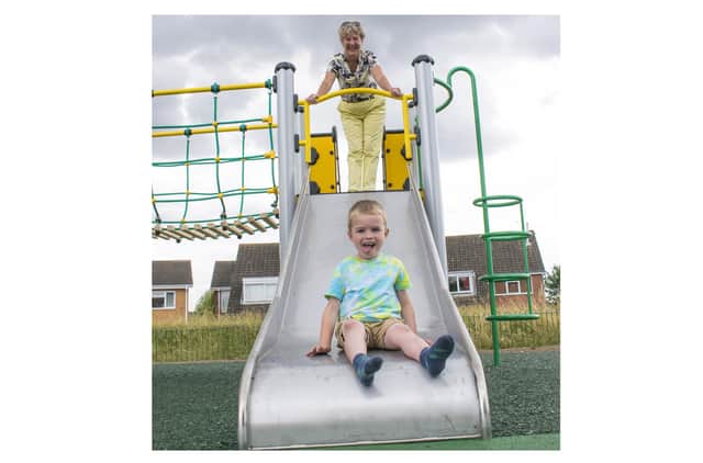 Cllr Kathryn Lawrence, Rugby Borough Council portfolio holder for operations and traded services, and Samuel explore the refurbished play area in Glaramara Close.