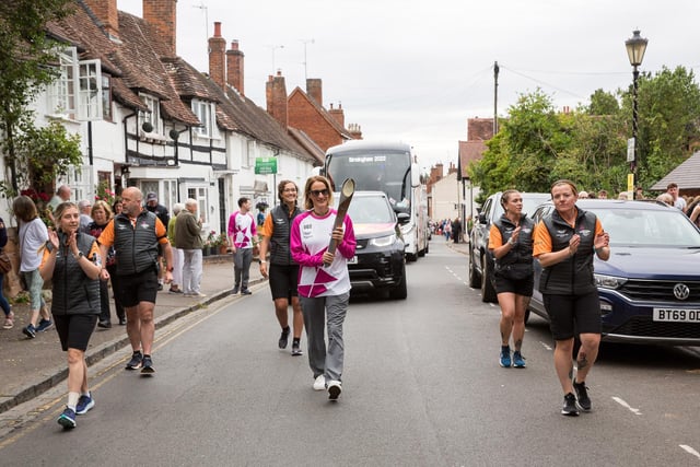 Batonbearer Melanie Barratt holds the Queen's Baton during the Birmingham 2022 Queen's Baton Relay on a visit to Kenilworth on July 22 (Photo by Nick England/Getty Images for Birmingham 2022 Queen's Baton Relay)