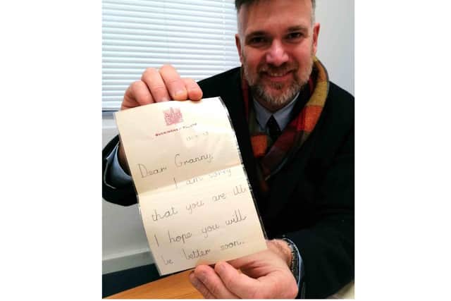 Charles Hansons with the childhood letter from Prince Charles. Photo by Hansons