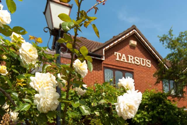 Plans for four houses on the site of the former Tarsus Hotel and Restaurant have been approved in spite of opposition from neighbours and local councillors.