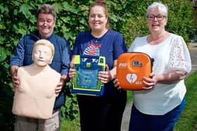 Steve Taylor, Gill Cleeve and Jo Carroll with the new defibrillator. Photo by David Fawbert Photography