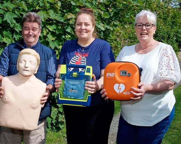 Steve Taylor, Gill Cleeve and Jo Carroll with the new defibrillator. Photo by David Fawbert Photography