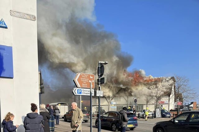 The thatched roof of The Shambles pub in the town centre on fire