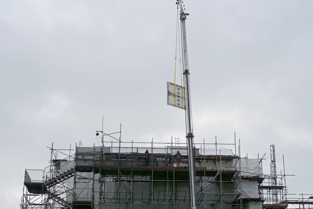 The Tabula Eliensis, being craned out of the roof of the building during building work on the house.