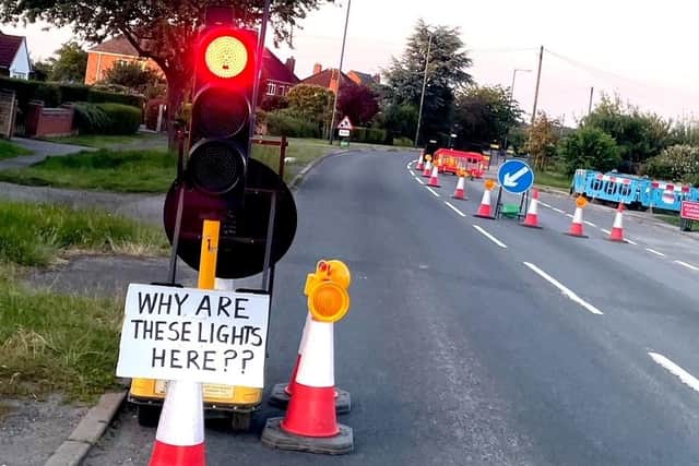 The temporary traffic lights and sign attached to them in Rugby Road, Cubbington. Picture supplied.