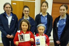 Members of The St Marks Rainbow Guides show off their letters from the late Queen Elizabeth and her son King Charles