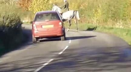 A huntsman moves into the middle of the lane, stopping a car near Shipston