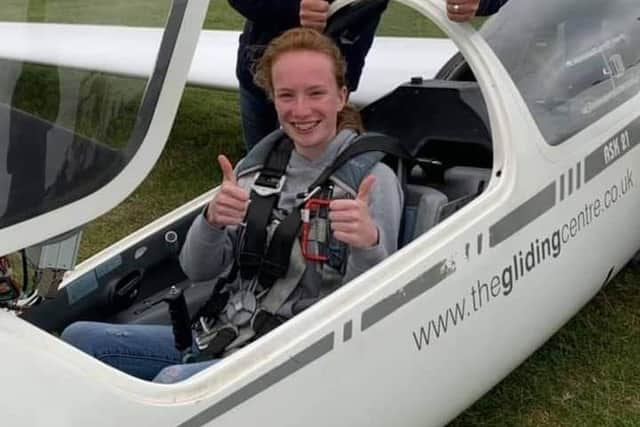 Smiling Lucy in her glider.