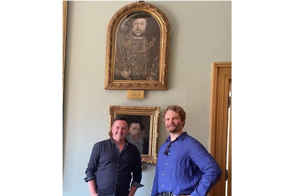 Historian Aaron Manning (left) and art historian Adam Busiakiewicz (right) with the rediscovered portrait of Henry VIII. Photo supplied