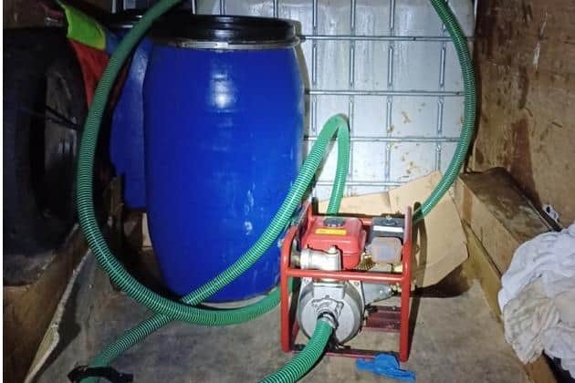 Officers found this inside the man's van - a 1,000-litre container, several large blue barrels and a petrol-powered pump with a flexible hose attached.